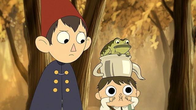 Greg, Wirt, and their frog walking through the woods